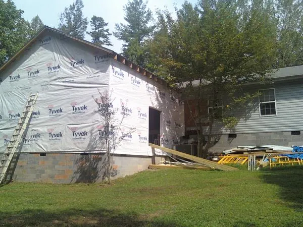 Tyvek wrapped gable on a new room addition beside an existing home in Hartline